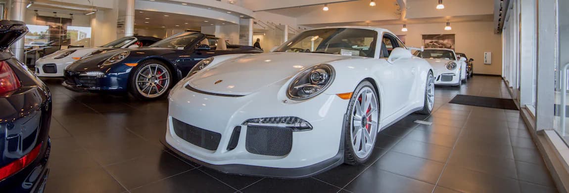 Interior view of Porsche Newport Beach with several Porsche vehicles in the shot